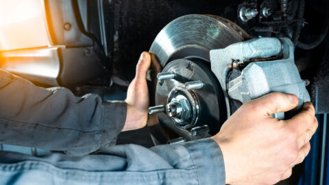 mechanic is installing brakes in a vehicle Harmony Automotive Denver Aurora Centennial Greeley Colorado