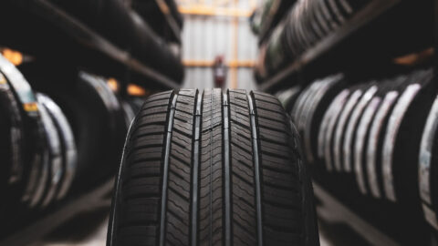 close up of tire with tire storage on shelves Harmony Automotive Denver Aurora Centennial Greeley Colorado