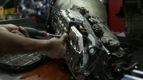 mechanic works on repairing a vehicle transmission Harmony Automotive Denver Aurora Centennial Greeley Colorado