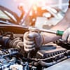 mechanic wearing gloves while tightening parts on a clean vehicle Harmony Automotive Denver Aurora Centennial Greeley Colorado